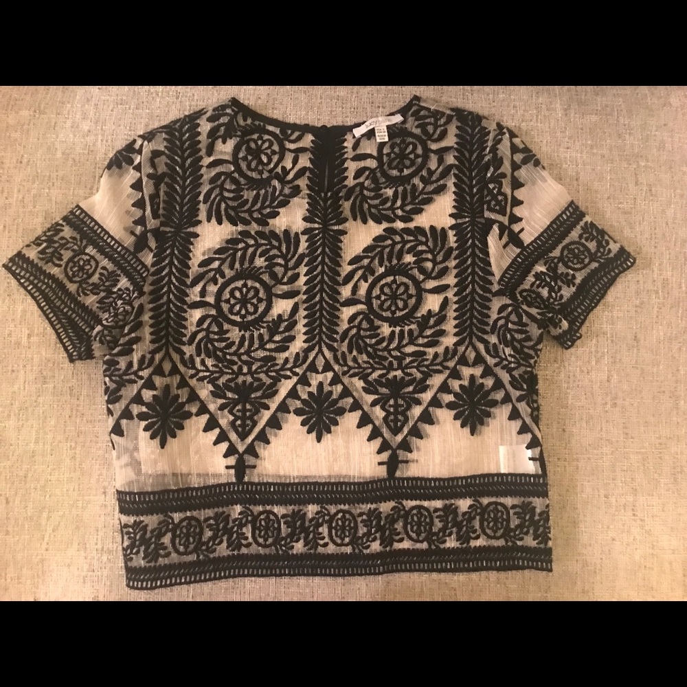 Cropped, embroidered short sleeve top.